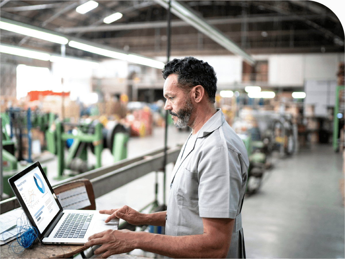 person on laptop in factory